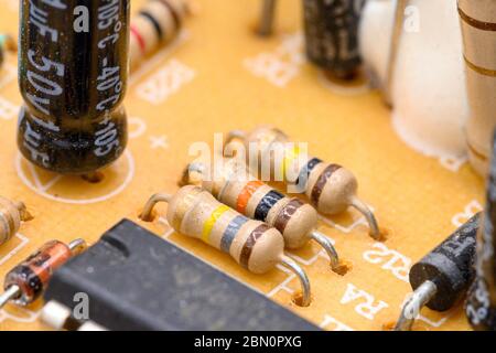 Old vintage printed circuit board with electronic components. Closeup with shallow DOF . Stock Photo