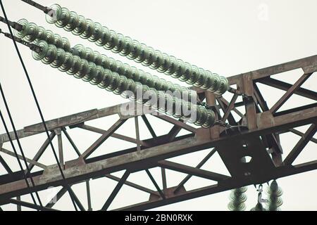 Electric communications wires power cable lines and pole. Power transmission pillar electrical wires electrification high lines. Close up view Stock Photo