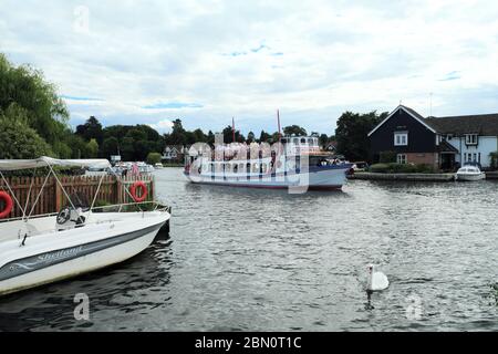 Passengers on The Cordon Rouge enjoying a trip down the Broads at Wroxham in Norfolk, England UK Stock Photo