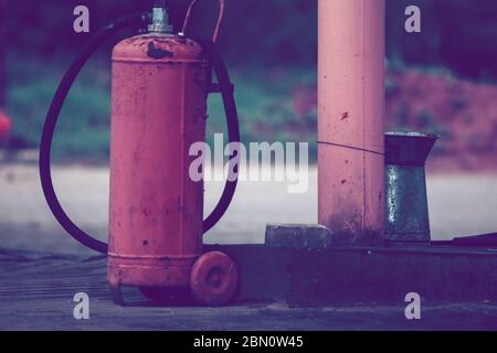 Vintage red Gas containers. Cooking gas cylinders on refill background Stock Photo