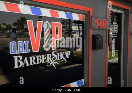 Orlando, United States. 11th May, 2020. Customers' reflections are seen in the front window of O.B.T. VIP Barber Shop on the first day that barber shops and salons in Florida were permitted to reopen amid the coronavirus pandemic. Credit: SOPA Images Limited/Alamy Live News Stock Photo