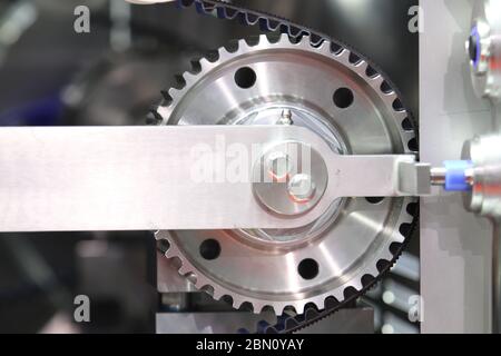 Black timing belt that synchronizes the rotation of gear drum in NUGGETS MEAT FORMING AUTOMATIC machine ; industrial engineering  background Stock Photo