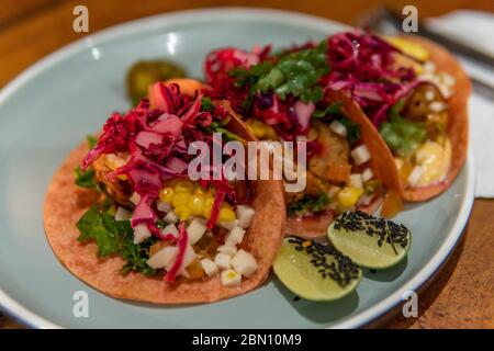 Three Vegetarian healthy soft shell tacos with lime on plate Stock Photo