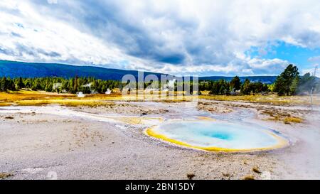 Steam coming from the colorful Chum geyser in the Upper Geyser Basin along the Continental Divide Trail in Yellowstone National Park Stock Photo