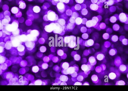 Abstract purple blurred bokeh background, defocused round violet, pink & white shiny dots texture, beautiful glowing pattern, bright holiday lights Stock Photo
