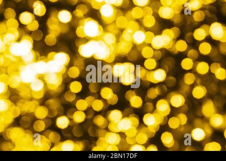 Abstract golden blurred bokeh background, defocused round yellow & white shiny dots texture, beautiful gold glowing pattern, bright holiday lights Stock Photo