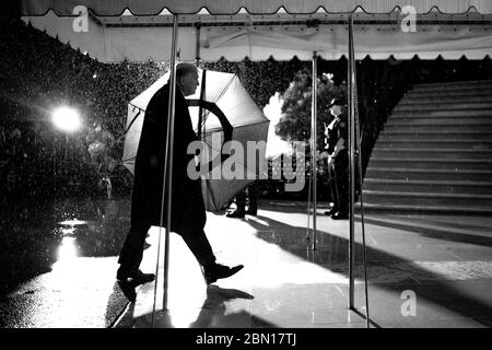 Washington, United States Of America. 05th May, 2020. President Donald J. Trump carries an umbrella as he walks into the White House Tuesday, May 5, 2020, returning from his trip to Phoenix People: President Donald Trump Credit: Storms Media Group/Alamy Live News Stock Photo