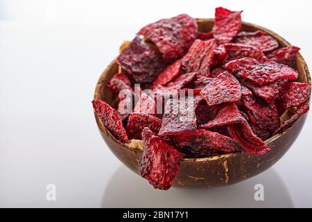 Diet healthy eating concept. Dried beet chips or baked beets in a bowl isolated on a white background. Organic natural food. Copy space. Stock Photo