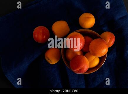 Ripe apricots on the dark blue linen napkin.  Stock Photo