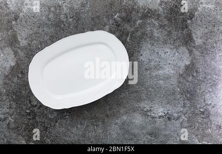 empty white service plate on a grey marble table Stock Photo