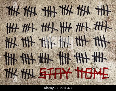 Concept of the end of the coronavirus pandemic, self-isolation and quarantine. Crossed out inscription Stay Home and Tally marks count signs counting Stock Photo