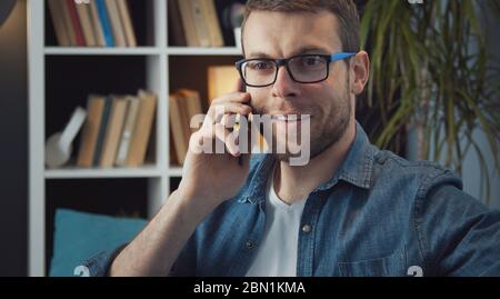 Bearded man talking on smartphone Stock Photo