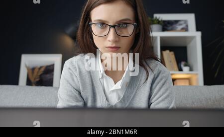 Woman working on laptop, headshot Stock Photo