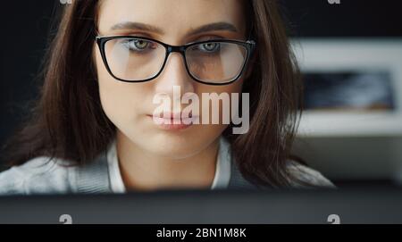 Woman working on computer, headshot Stock Photo