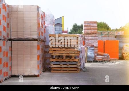 Construction Materials. Building materials and pallets for construction in construction store. Pile of brickwork at construction site. Stock Photo