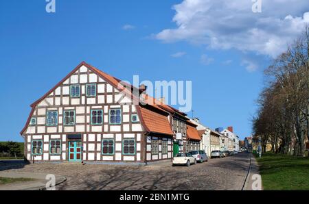 Typical fachwerk house of old Klaipeda, Lithuania medieval town and cobbled pavement street. German style buildings of Middle Ages. Stock Photo