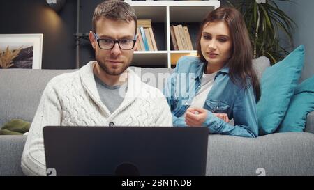 Couple looking at laptop screen Stock Photo