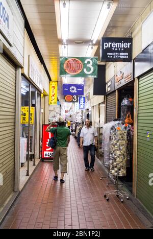 Motomachi, Sannomiya, Hyogo/ Japan: Japanse people walking along Kokashita: historic shopping arcade under jr kobe line which is deserted today Stock Photo