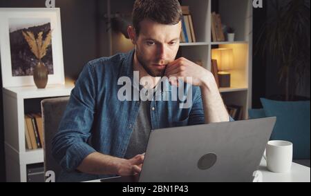 Man using laptop working home Stock Photo