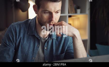 Man using computer working remotely Stock Photo
