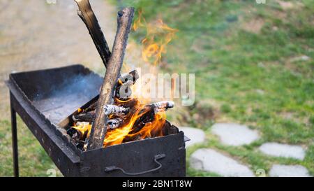 Grill flame. BBQ on nature. Wood fire prepared for barbecue. Close up fire burning in the brazier. Barbecue on the grill Stock Photo