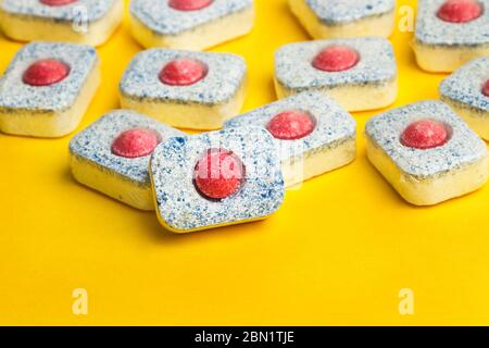 Dishwasher tablets on a yellow background Stock Photo