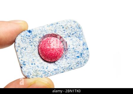 Man fingers holding a dishwasher tablet on a white background Stock Photo