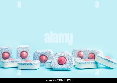 Dishwasher tablets on a light blue background Stock Photo