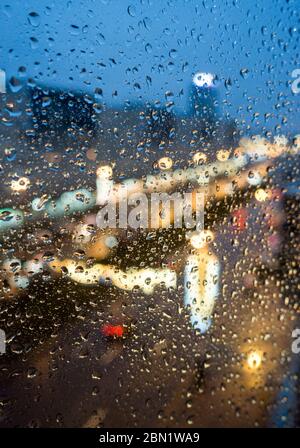 focus on drops on the window- top view of Moscow Avenue in the evening festive illumination through a window pane with raindrops in Saint Petersburg, Stock Photo