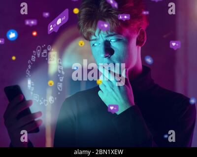 Beautiful man with white eyes using interface modern technology and digital layer effect for social media displaying. Bright neon icons around her. Concept of digital, tech, communication, future. Stock Photo