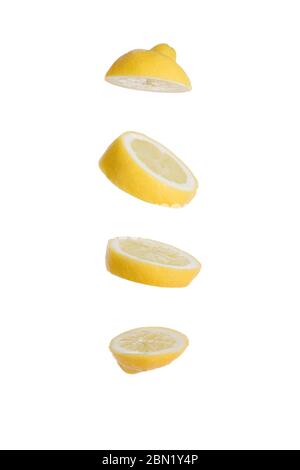 Sliced lemon isolated on white background floating in air with four large slices flying Stock Photo