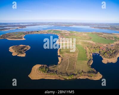 Aerial view of beautiful Kal village (former Kehlen or Kielno, East Prussia) located on Swiecajty Lake shore, Mazury, Poland
