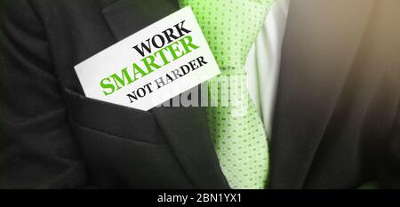 Card with a motivational message written on it Work smarter not harder in upper pocket of business suit. Business concept Stock Photo