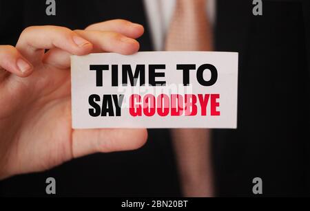 Time to Say Goodbye words on a card in hand of businessman. Business agreement termination concept Stock Photo