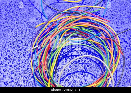 Copper cables of various colors, transmission of electric current through copper cables protected by colored plastics. Stock Photo
