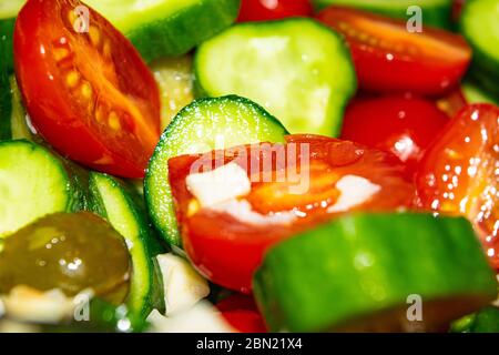 Vegetable salad sliced tomatoes, cucumbers, onions and pickles. Close up. Healthy food, fitness diet Stock Photo