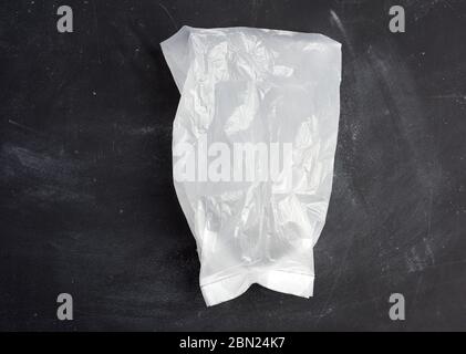 white transparent plastic bag for products on a black background, top view Stock Photo