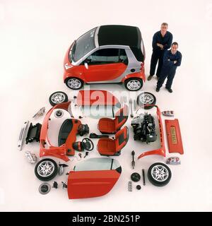 2001 Smart Two car and components that make up the car laid out on display. Stock Photo