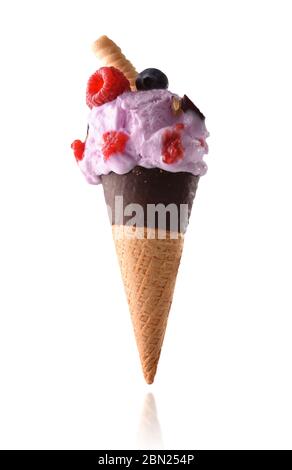 Semi-dipped chocolate cone with berries flavored cream ice cream with pieces of fruit blueberries and raspberries isolated with white background. Stock Photo