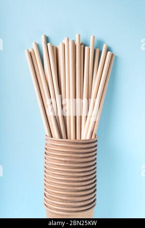 Eco cups with drinking straws on light grey background. Flat lay, view from above. Stock Photo