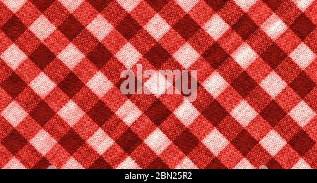 The texture of the bright red of binding gingham fabric. Red textile background. Fabric plaid. Close-up Stock Photo