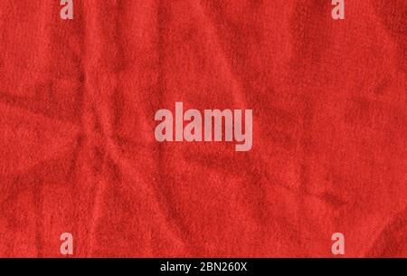 Bright red texture of binding fabric. Red textile background with natural folds. Close-up Stock Photo