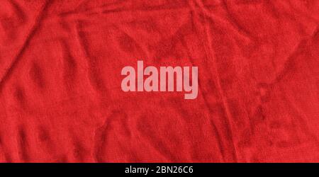 Bright red texture of binding fabric. Red textile background with natural folds. Close-up Stock Photo