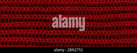 Bright red texture knitted wool scarf. Red textile background knitwear. Close-up Stock Photo