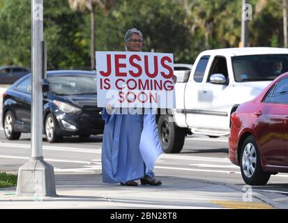 PARKLAND, FL - MAY 11: A woman is seen holding a sign that reads 'Jesus is coming soon' during the Coronavirus COVID-19 pandemic on May 11, 2020 in Parkland, Florida Credit: mpi04/MediaPunch Stock Photo