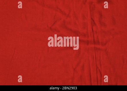 Bright red texture of knit fabric. Red textile background with natural folds. Close-up Stock Photo