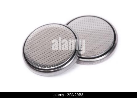 Flat lithium round button cell battery isolated over white background Stock Photo