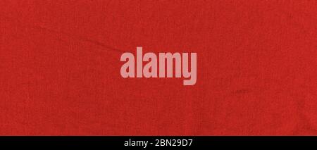 Bright red texture of knit fabric. Red textile background with natural folds. Close-up Stock Photo