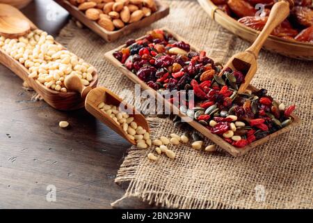 Dried fruits, various nuts and seeds on a old wooden table. Stock Photo