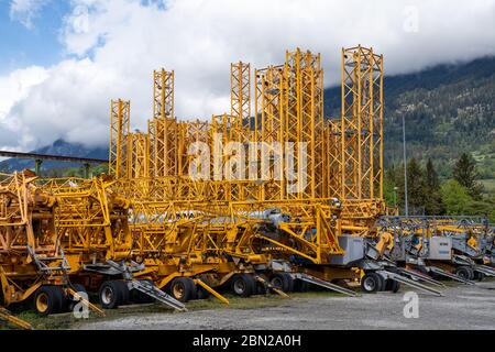 A view of many industrial cranes ready to be installed on construction sites Stock Photo